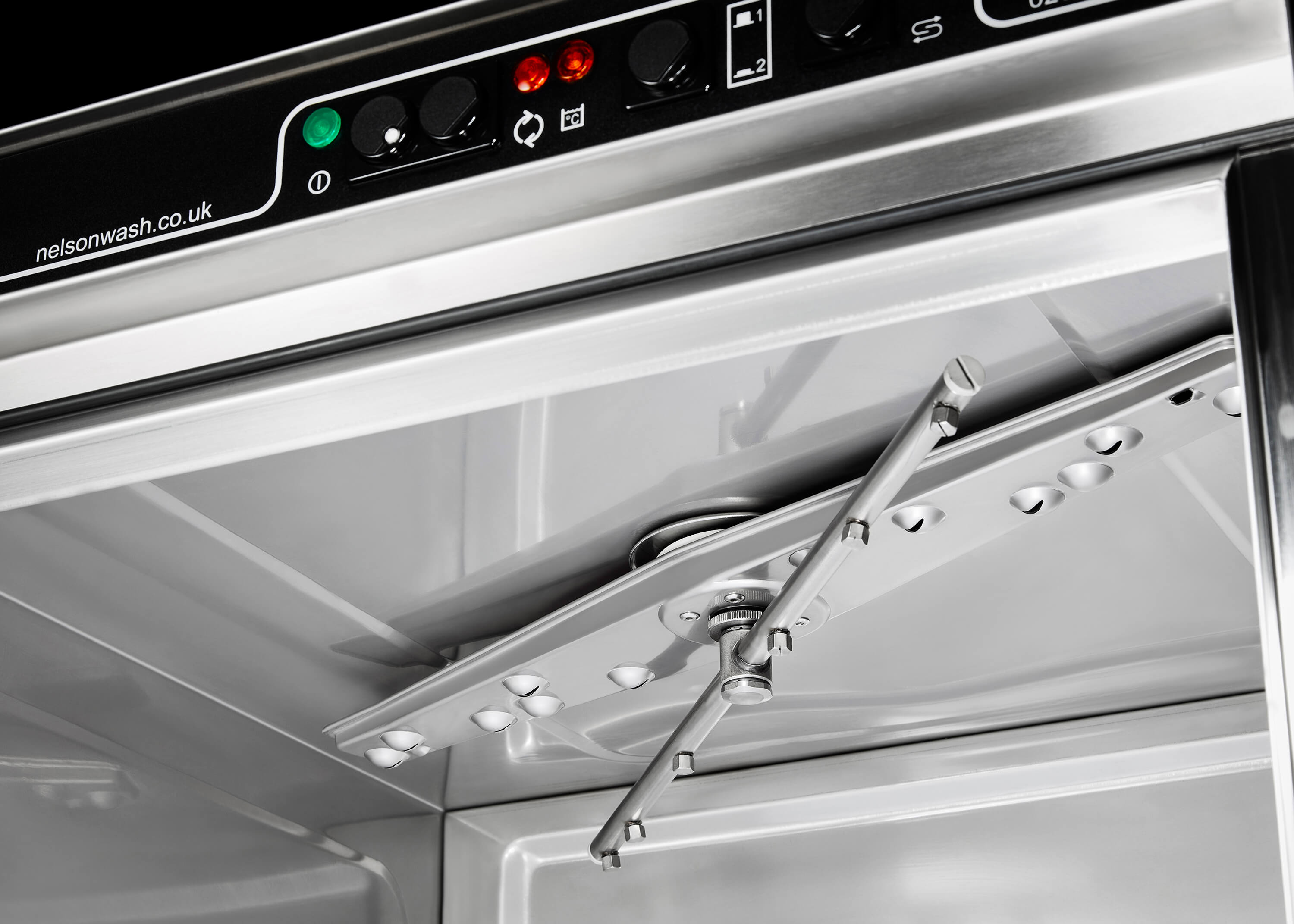 The stainless steel upper wash and rinse arms on the SW50 commercial dishwasher