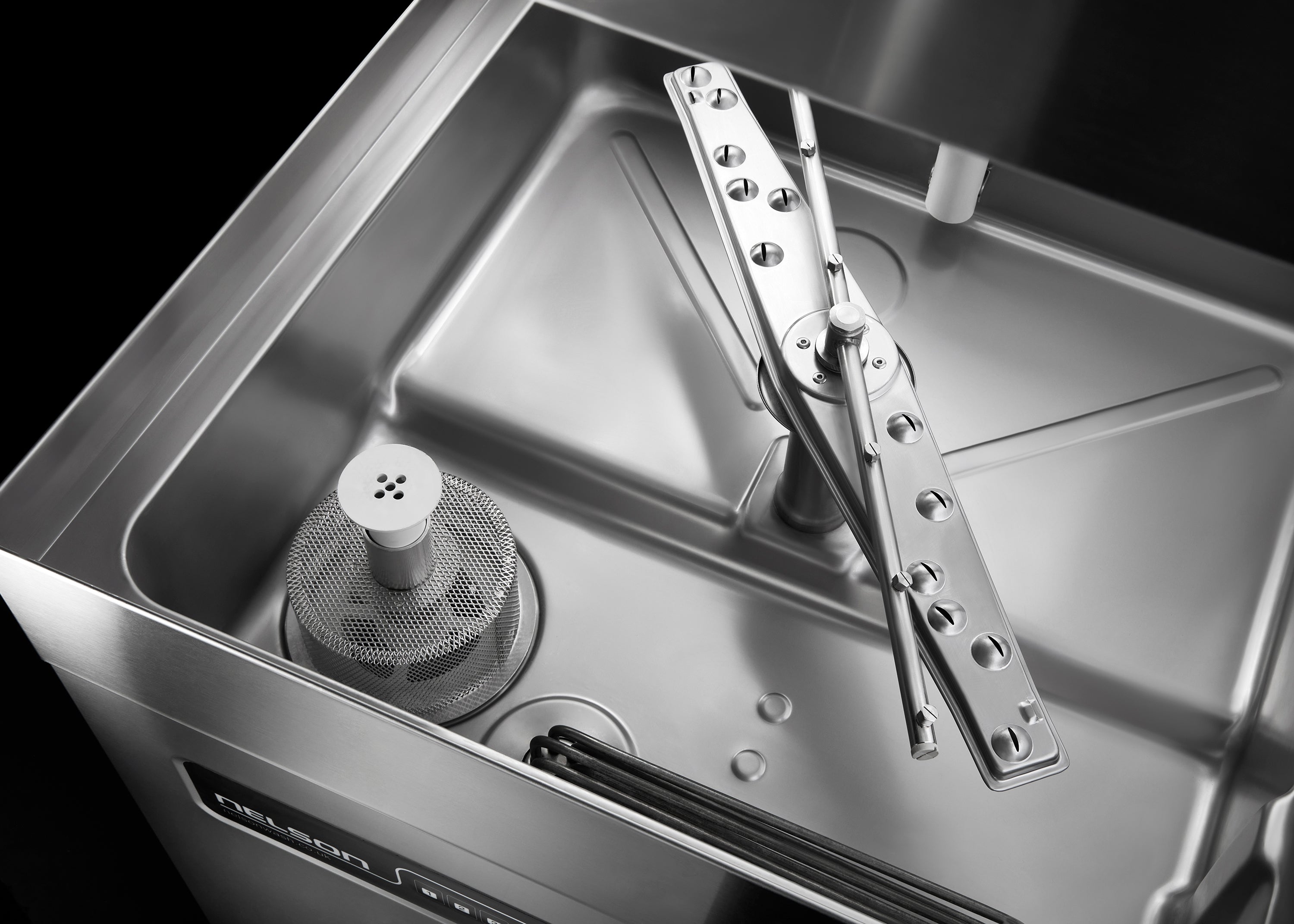 The stainless steel wash tank on an SW55 commercial dishwasher
