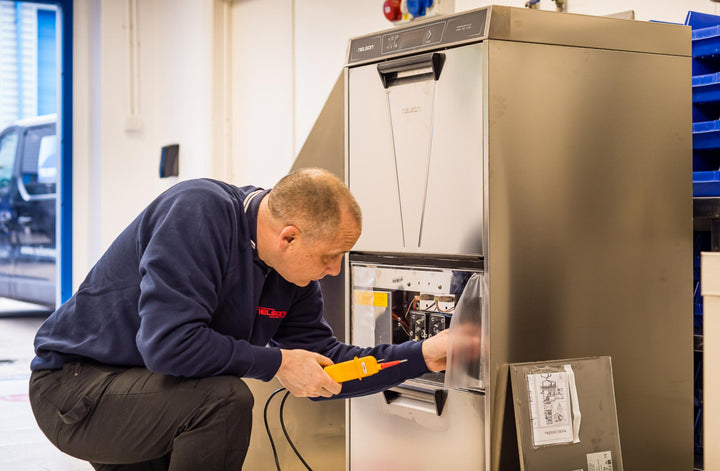 Nelson engineer servicing a commercial dishwashers